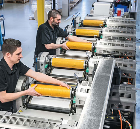 Print production specialist inspecting sheets